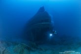 The ship is located inverted in the sea bottom and a big part of its load is spread around the wreck.