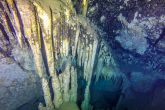 Stalactites and stalagmites reveal the existence of the cave before it enters this seawater.