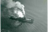 Τhe moment after the first bomb struck. The ship was hit in the engine room and steam is being emitted from the steam pipes. The photo was taken at the moment when the plane makes a turn to launch the second attack, which will sink SIFNOS. Archive of Dimitris Galon